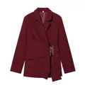 Detail of burgundy blazer featuring a gold buckle and elegant draped waist design. - XS / Tops / Burgundy