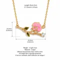 Detailed view of retro copper necklace with pink enamel flower and olive green crystals - April