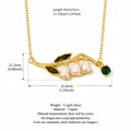 Vintage copper lily of the valley necklace with white enamel flowers and green gem charm - May