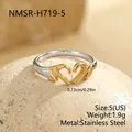 Detailed macro view of two-tone stainless steel ring with a hand heart gesture design - Small (NMSR-H719-5)