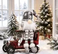 Detail showing a gray Christmas gnome sitting on a red vintage car in a snowy scene - Long Leg with LED / Gray