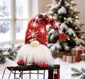 Detailed view of a plush Christmas gnome with snowflake hat in a festive snowy setting - Short Leg with LED / Red