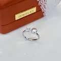 Detailed macro view of an adjustable silver ring with a pink pearl and clear crystal. - Adjustable Open / Silver Base with Large Rhinestone Style / Purple