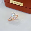 Close-up detail of elegant rose gold adjustable ring with a large freshwater pearl - Adjustable Open / Large Flower Rhinestone Rose Gold Style / White