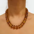 Elegant amber acrylic flat round bead necklace featuring golden spacers on model - Brown(32915)