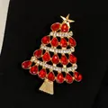 Detailed macro view of Christmas tree brooch with red rhinestones and golden finish - Red Rhinestone Christmas Tree Style (WG-0757) / Gold