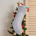 Elegant grey cable-knit Christmas stocking hanging beside a decorated festive tree - Grey Knitted Stocking