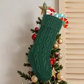 Dark green cable-knit Christmas stocking hanging in a festive holiday setting - Green Knitted Sock
