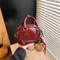 Elegant wine red women's mini bowling handbag featuring a cute bear charm and textured finish - With Charm / Burgundy