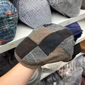 Detailed view of a retro patchwork flat cap with herringbone and tweed patterns - One Size (54-58cm) / Khaki & Beige