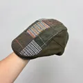 Close-up of retro patchwork flat cap featuring mixed herringbone and plaid patterns. - One Size (54-58cm) / Army Green Color Block