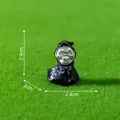 Miniature Halloween skull figurine with black hood and purple bow on green grass background - Soul of No Face / 2.9x2.4x2cm