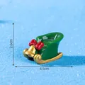 Decorative miniature green Christmas sleigh with red bow and gold bell, size 4.5x2.6cm - 2.6x4.5cm