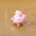 Miniature white cat figurine sitting on a pink sofa for dollhouse desk decoration - Pink
