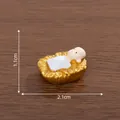 Miniature resin baby Jesus figurine in golden manger, 2.1cm length dimensioned variant view. - Jesus in Manger / Style 1