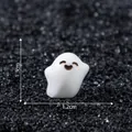 Cute white ghost miniature figurine on black gravel background with dimensions 1.3x1.2cm - 1.3x1.2cm