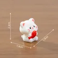 Miniature white ceramic style cat figurine holding a red fish 2.3cm height desk decoration - 2.3x1.9x1.9cm