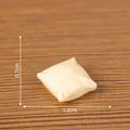 Miniature cream dollhouse pillow accessory with dimensions showing 1.2cm width and 0.7cm height - Throw Pillow