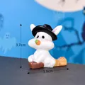Cute miniature Halloween ghost rabbit figurine wearing witch hat sitting on broomstick - Witch Rabbit