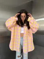 Styling view of a pink and yellow oversized plaid shirt for women's casual wear - S / Tops / Yellow