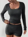 Close-up of women's charcoal ribbed long-sleeve top and slim yoga shorts two-piece set. - S / Top And Bottom / Gray