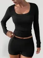 Close-up detail of women's black ribbed long sleeve top and matching slim fit shorts set - S / Top And Bottom / BLACK
