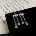 Elegant pearl tassel earrings with silver heart-shaped pendants on black velvet - Three-Artificial Pearl Tassel (WF3)