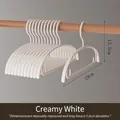 Close-up detail of cream white non-marking baby plastic hanger with 29cm width measurement - White