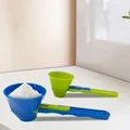 Close-up of a blue sliding scoop filled with white protein powder for easy measuring - 2 Pcs/Set / Blue/Green