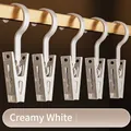Five cream white multi-purpose plastic storage clips with hooks for socks and clothes. - White
