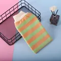 Detailed view of the green and orange striped exfoliating bath glove with an elastic cuff - Yellow + Green