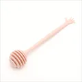 Pink plastic honey dipper stirrer featuring a unique and cute hand shaped handle detail - Pink