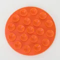 Vibrant orange round silicone mat with multiple suction cups for anti-slip table protection - Orange