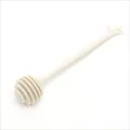 Creamy white plastic honey dipper stirrer with creative hand-shaped handle for coffee tea - Beige