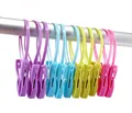 Detail view of colorful plastic clothes pegs with integrated hanging loops shown on a rod - Loop Rope Style (A2527) / Set of 12 / Multicolor Combo