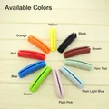 Various bright colors of ergonomic silicone shopping bag handle grips on wood backdrop - Coffee