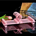 Adjustable pink plastic pants hangers with stackable hooks for closet storage - Pants Hanger / Pink