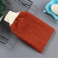 Detailed view of a thick exfoliating bath mitt with textured orange fabric and cuff - Red