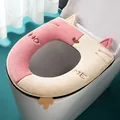 Soft plush cat-ear toilet seat cover in pink and cream color-block design, universal fit. - Pink + White