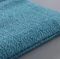 Close-up macro detail of blue honeycomb textured exfoliating bath towel fabric surface - Blue