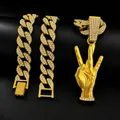 Macro detail of iced-out gold Cuban link necklace with three-finger peace hand pendant - 18 Inch Cuban Chain / Gold
