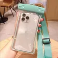 Mint green waterproof phone pouch with adjustable strap for swimming and drifting - Glow in the Dark / Light Blue