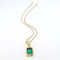 Detail of vintage gold rope chain necklace with a large emerald green gemstone pendant. - Rope Chain Necklace / 20 inch / Gold Green
