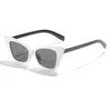 Side view of retro cat-eye sunglasses featuring white frames and dark tinted lenses - White Frame Black Legs