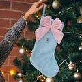 Light blue plush Christmas stocking featuring a large pink bow and bell on a festive tree - Sky Blue