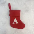 Red knitted Christmas stocking with white embroidered letter A on textured background - Letter A / 18*15cm