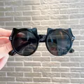 Cute black cat-ear style sunglasses for children providing UV protection and style - Glossy Black/Grey Lens