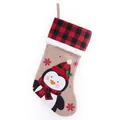 Festive burlap Christmas stocking featuring red and black plaid cuff and penguin design - Penguin