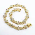 Detailed view of iced-out gold-tone four-leaf clover and infinity link Cuban chain necklace - 18inch(45cm) / Gold