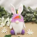 Detailed view of handmade plush Easter bunny gnome doll with purple fuzzy hat and carrot - Rose Red
